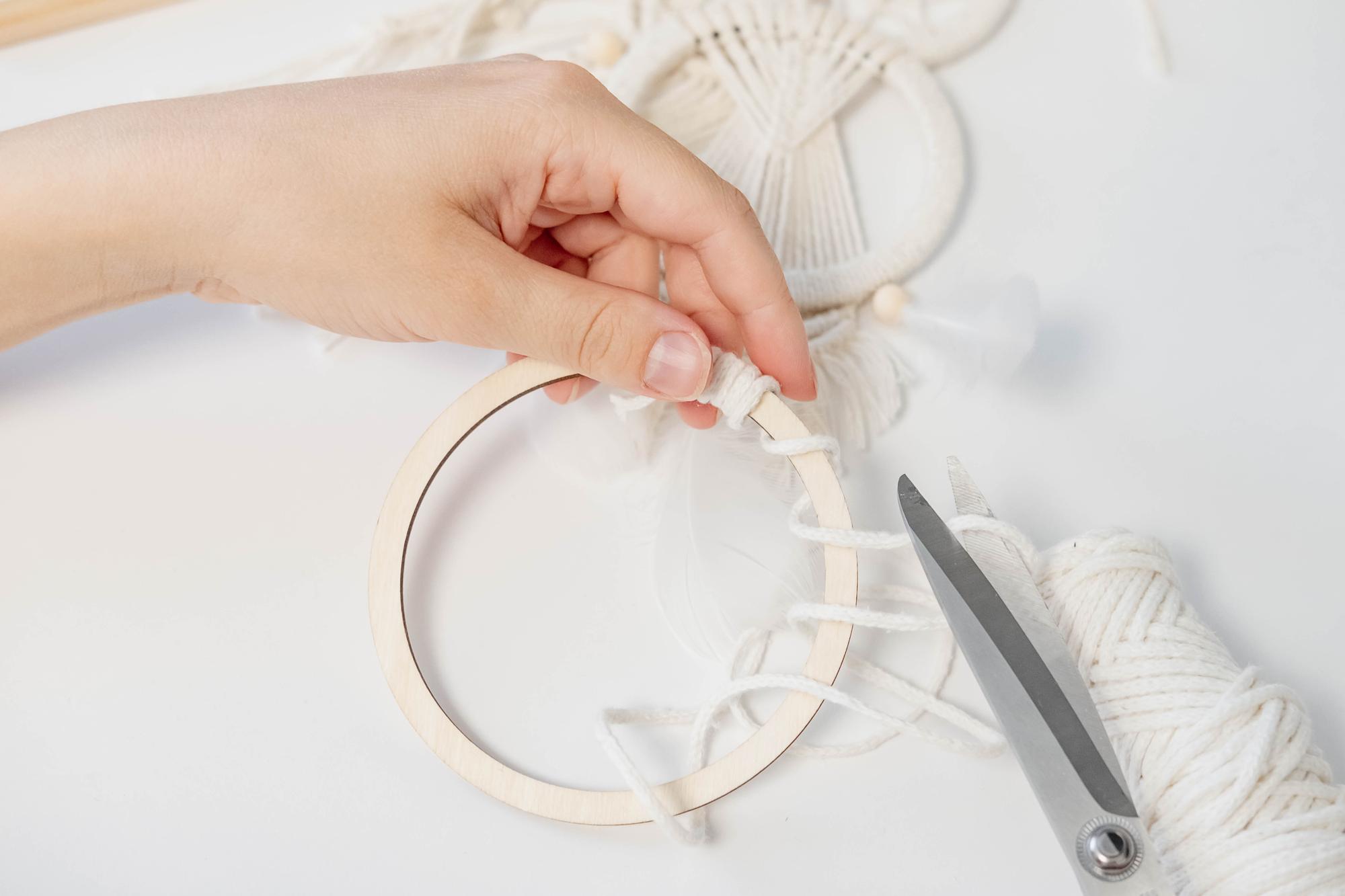 artisan hands working on hoop embroidery